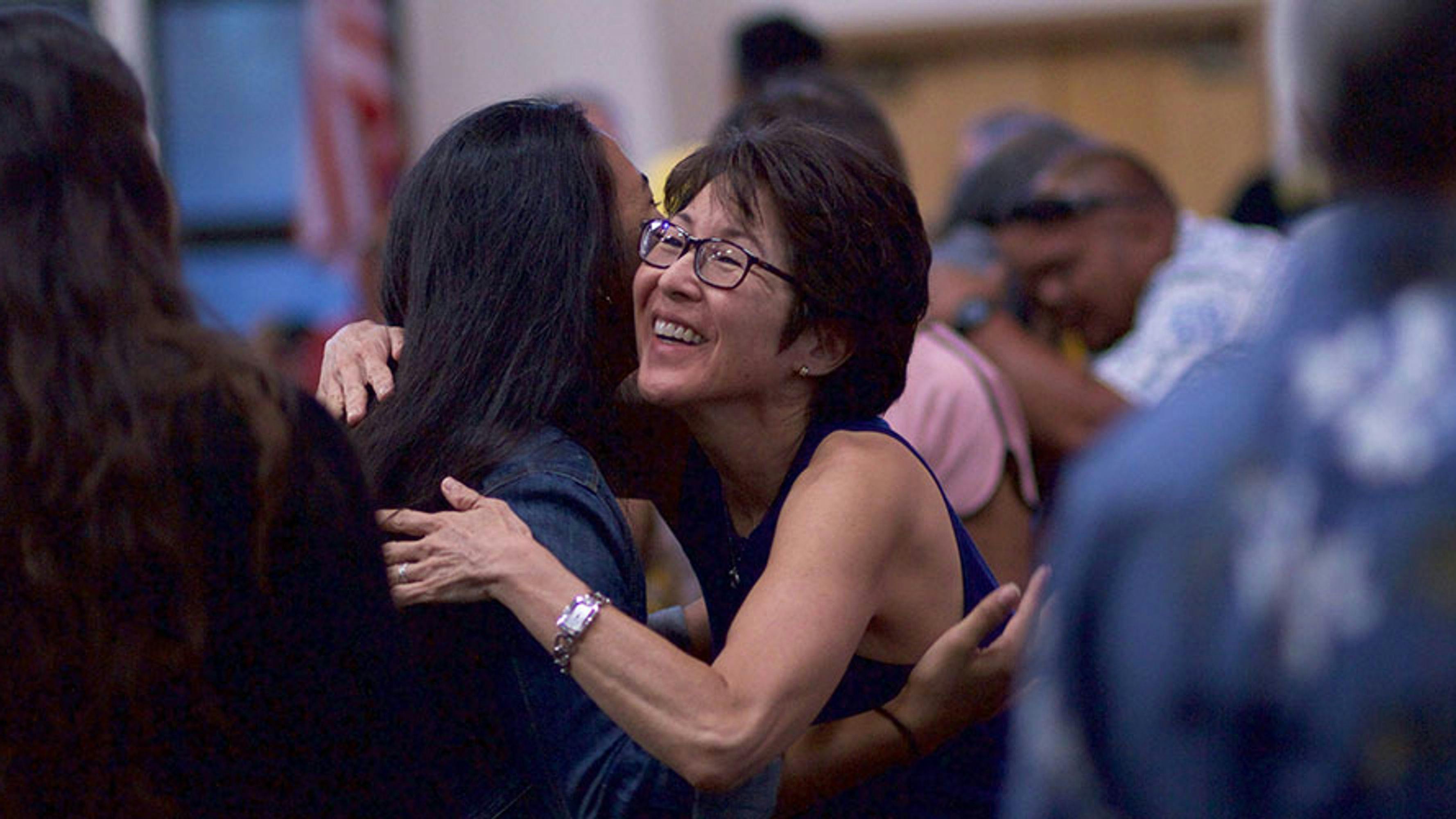 Two AAPI women hugging during a SWEC Town Hall