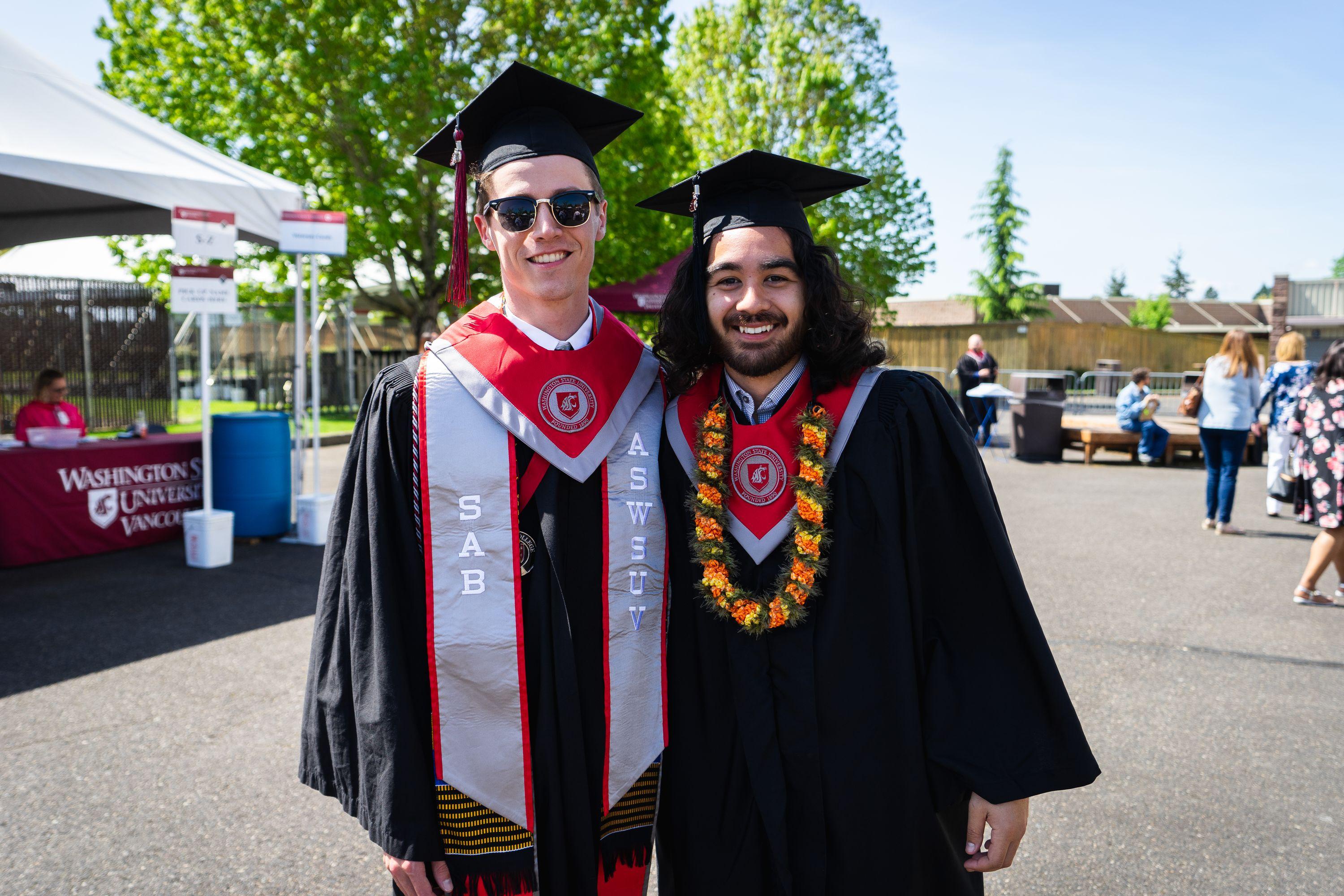 Two young men in caps and gowns at graduation from Washington State University Vancouver