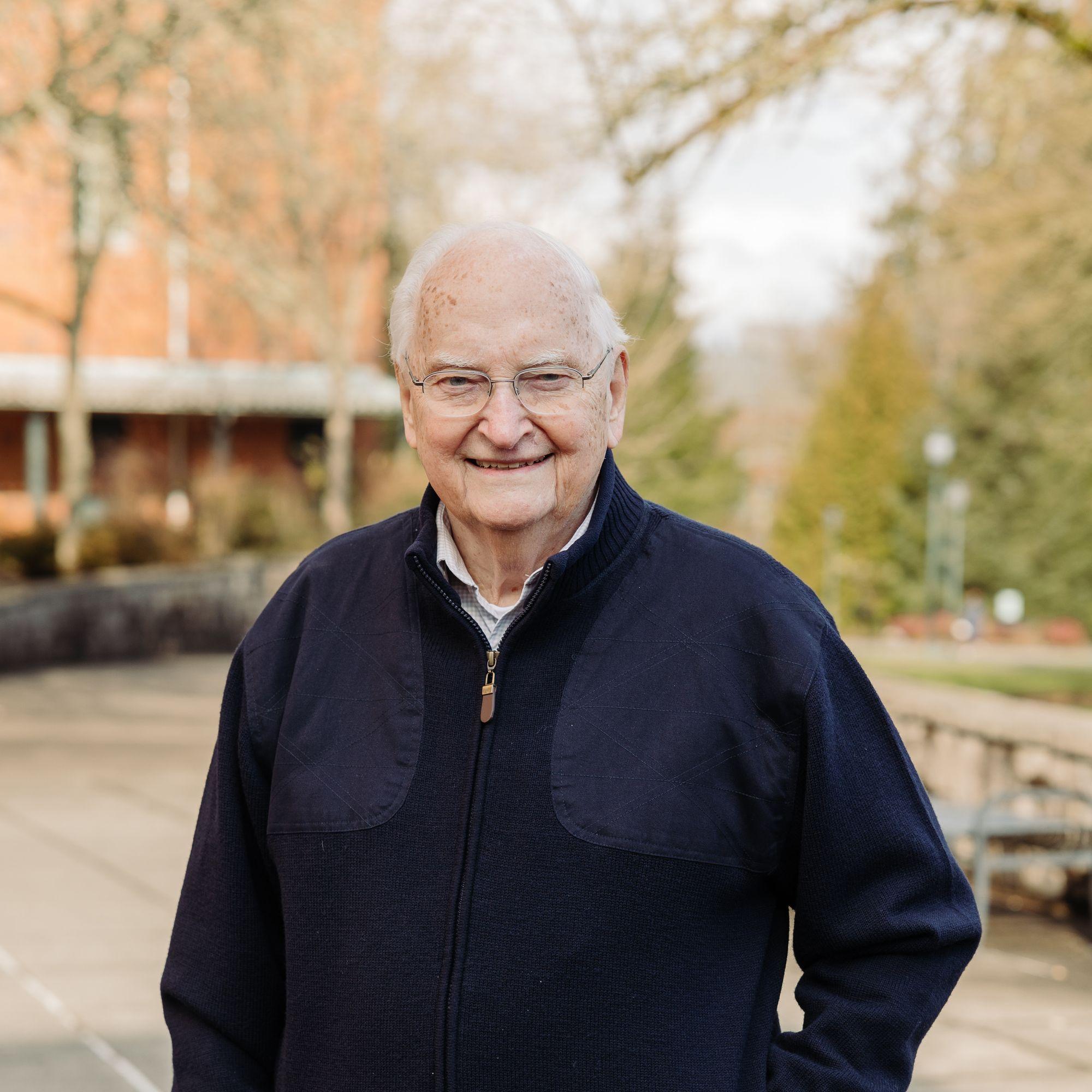 Ken Kirn stands smiling on the WSU Vancouver campus