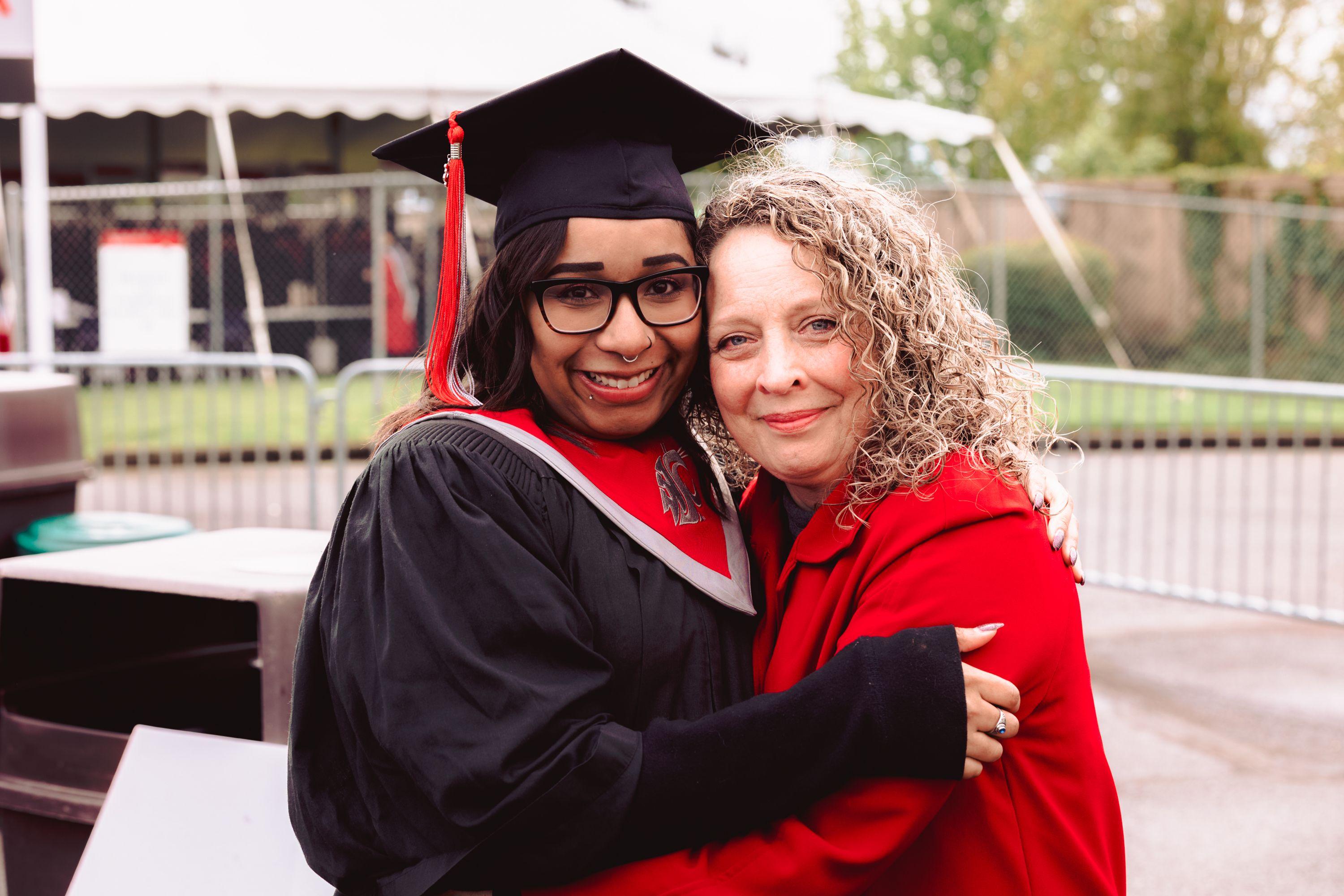 A Black female student hugging our Senior Scholarship Manager, Deanna Green