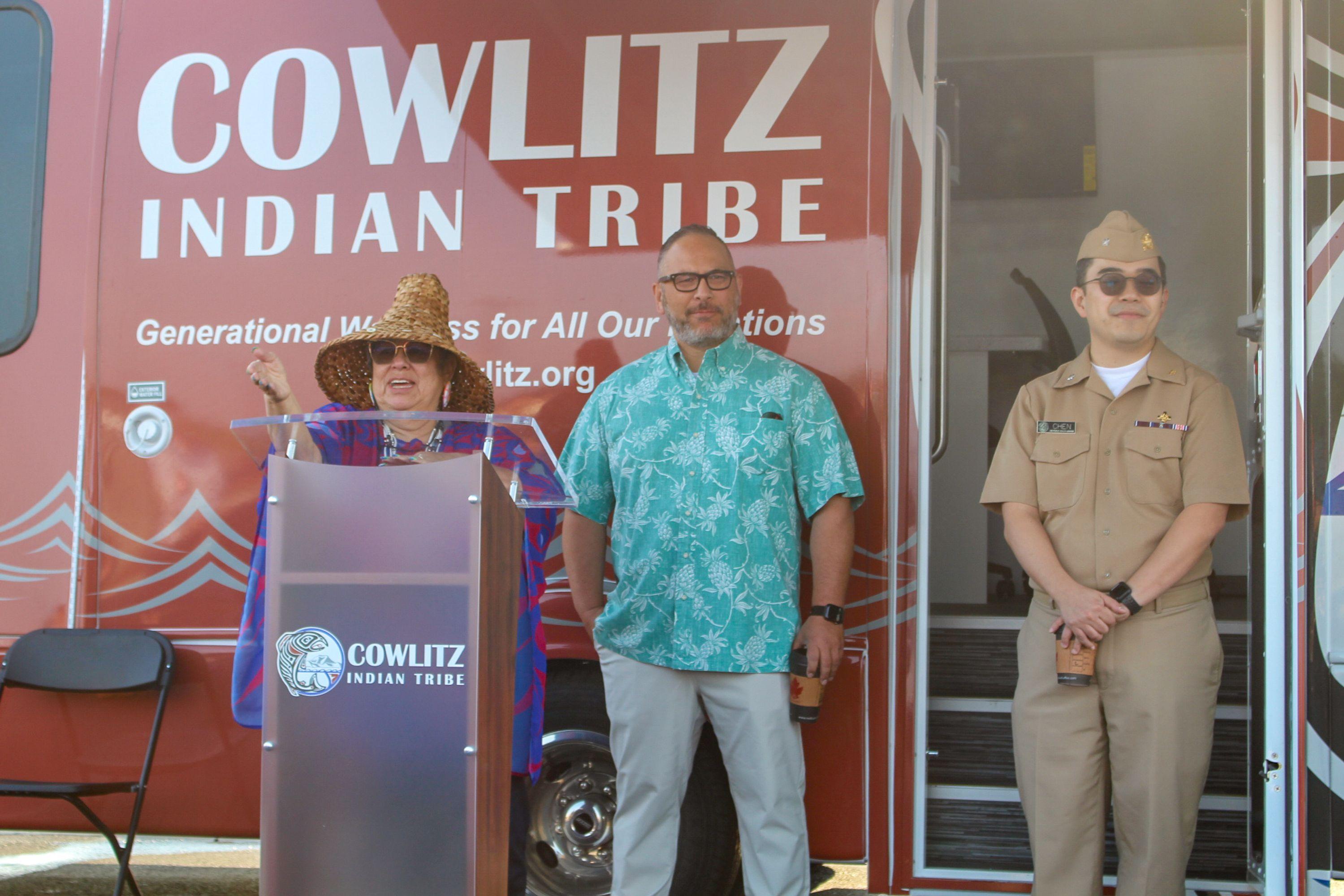 A Native woman and two men standing in front of the Cowlitz Indian Tribe's new wellness van