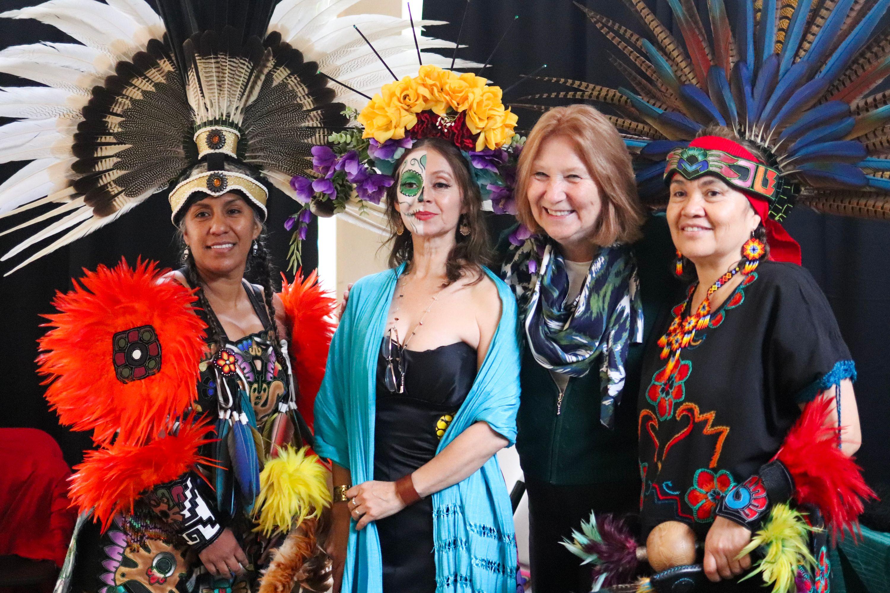 Three women in traditional Mexican wear from Vancouver Ballet Folklorico with Mayor Anne McEnerny-Ogle