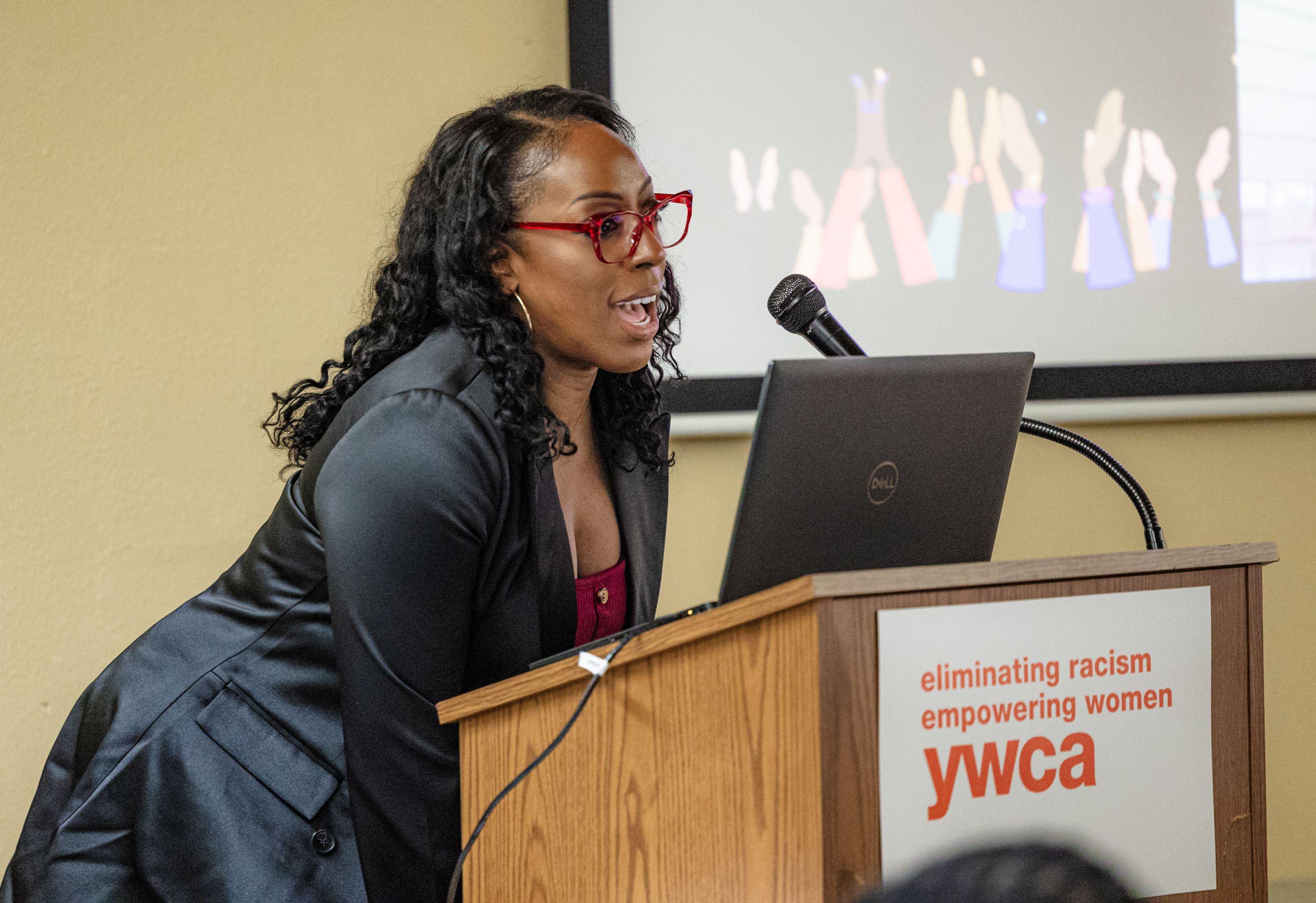 A Black woman talking at a podium during an NAACP ACT-SO gathering at the YWCA in Vancouver, WA