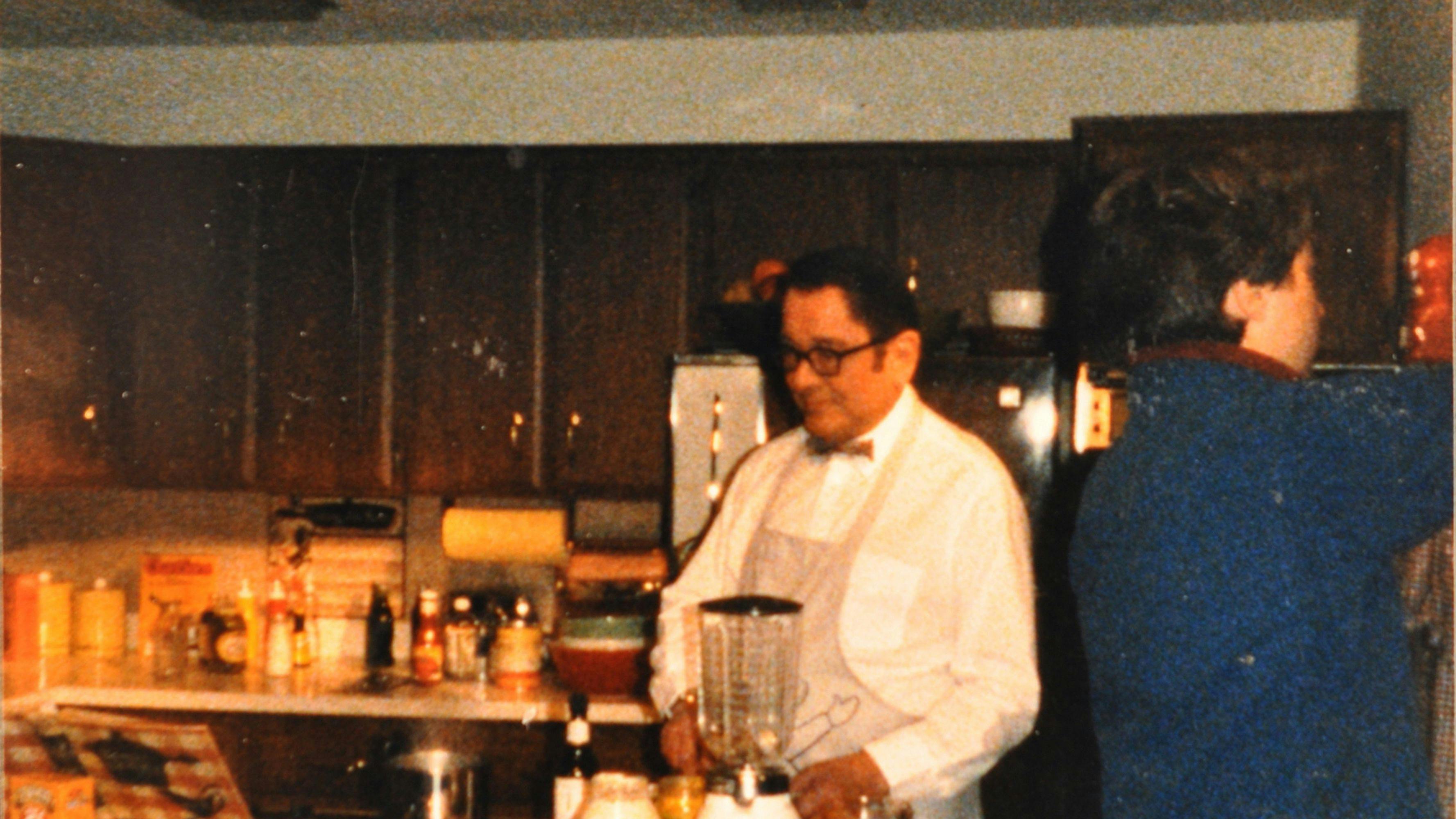 George Propstra in a kitchen making sauce with a blender