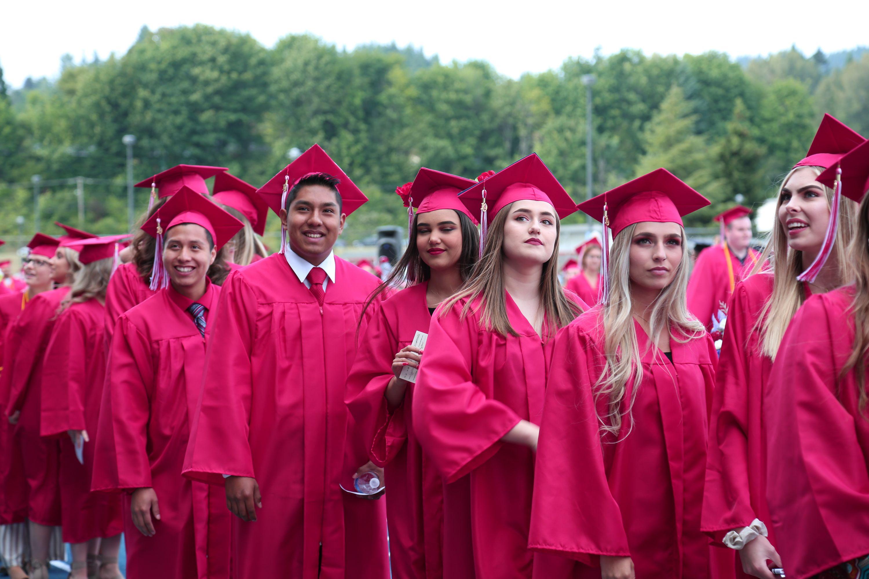 Lower Columbia College students walking toward graduation in their caps and gowns