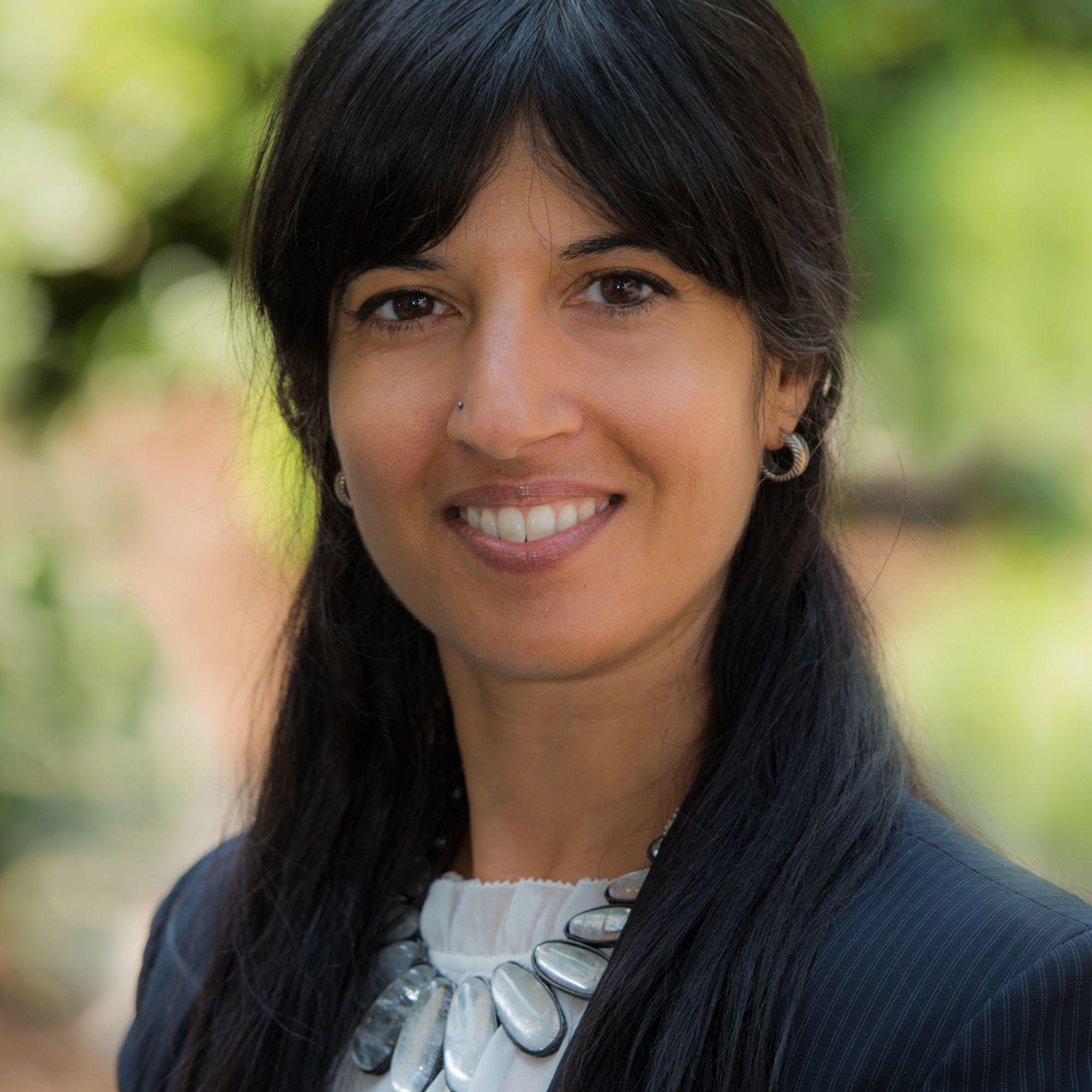 Esra, an Indian woman, smiling at the camera