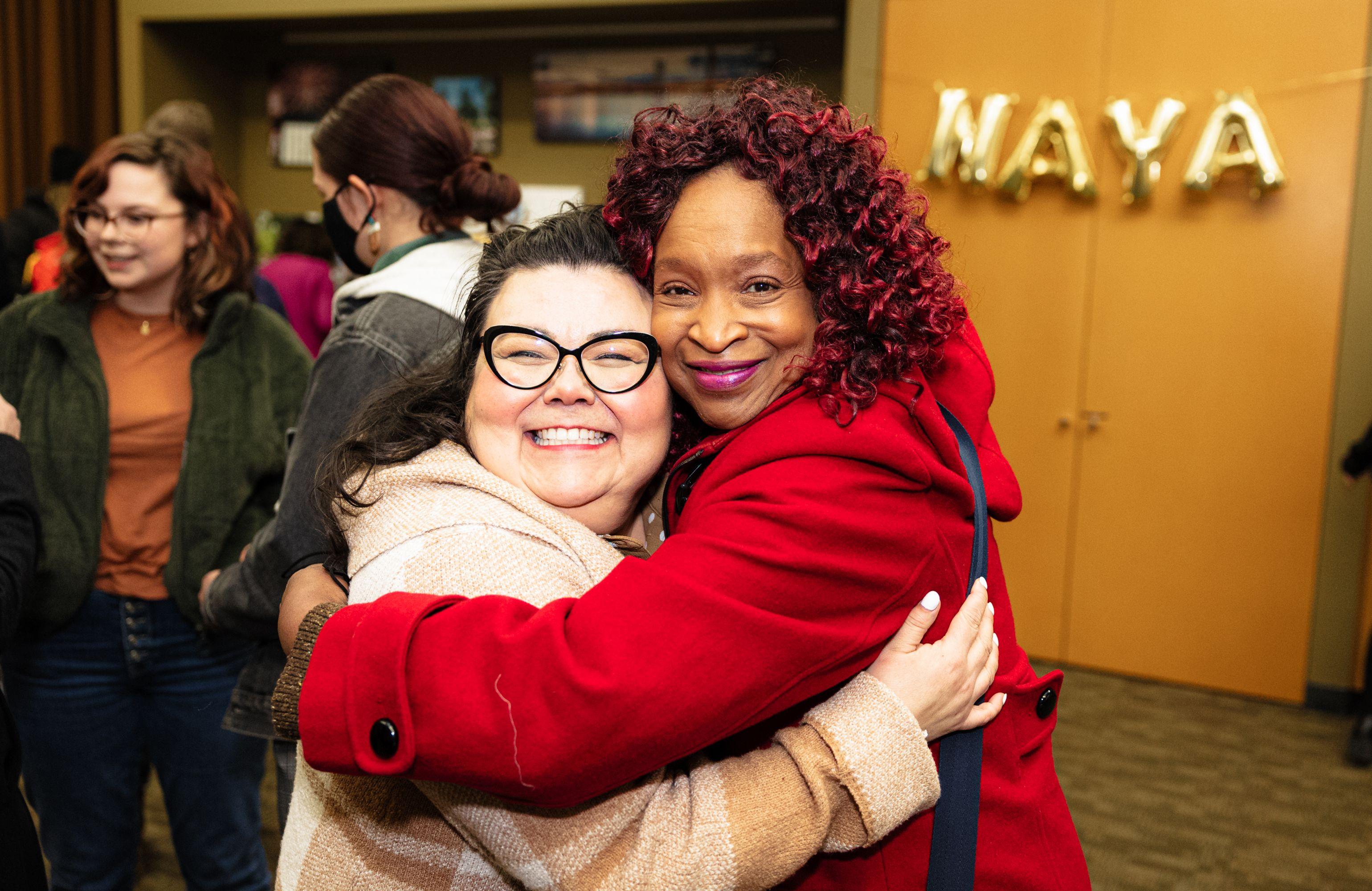 Shelia Davis of Fourth Plain Forward and Karen Morrison of Odyssey World International Education Services hugging and smiling at the camera at a NAYA gathering in 2023.