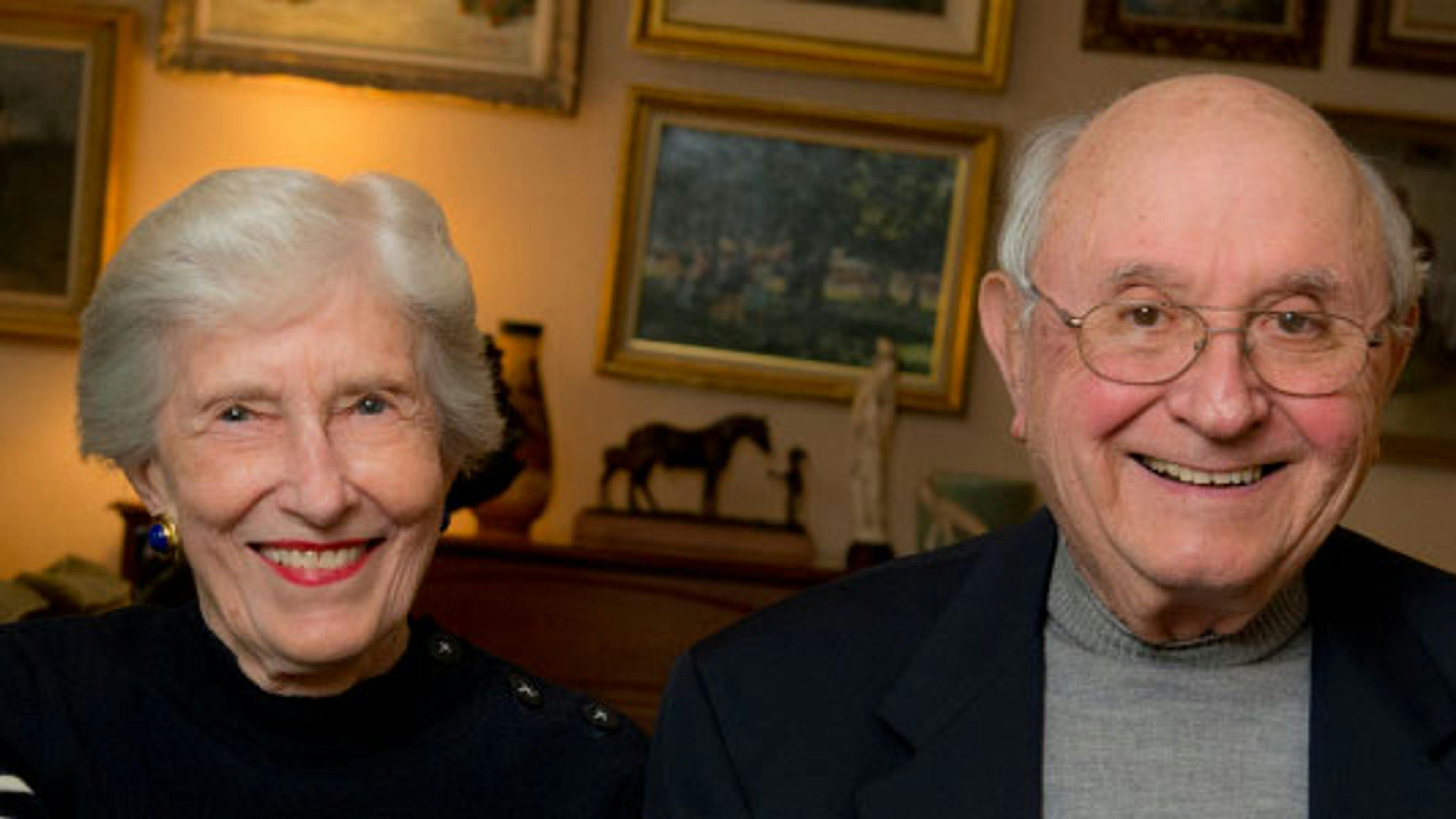 An elderly couple smiling at the camera