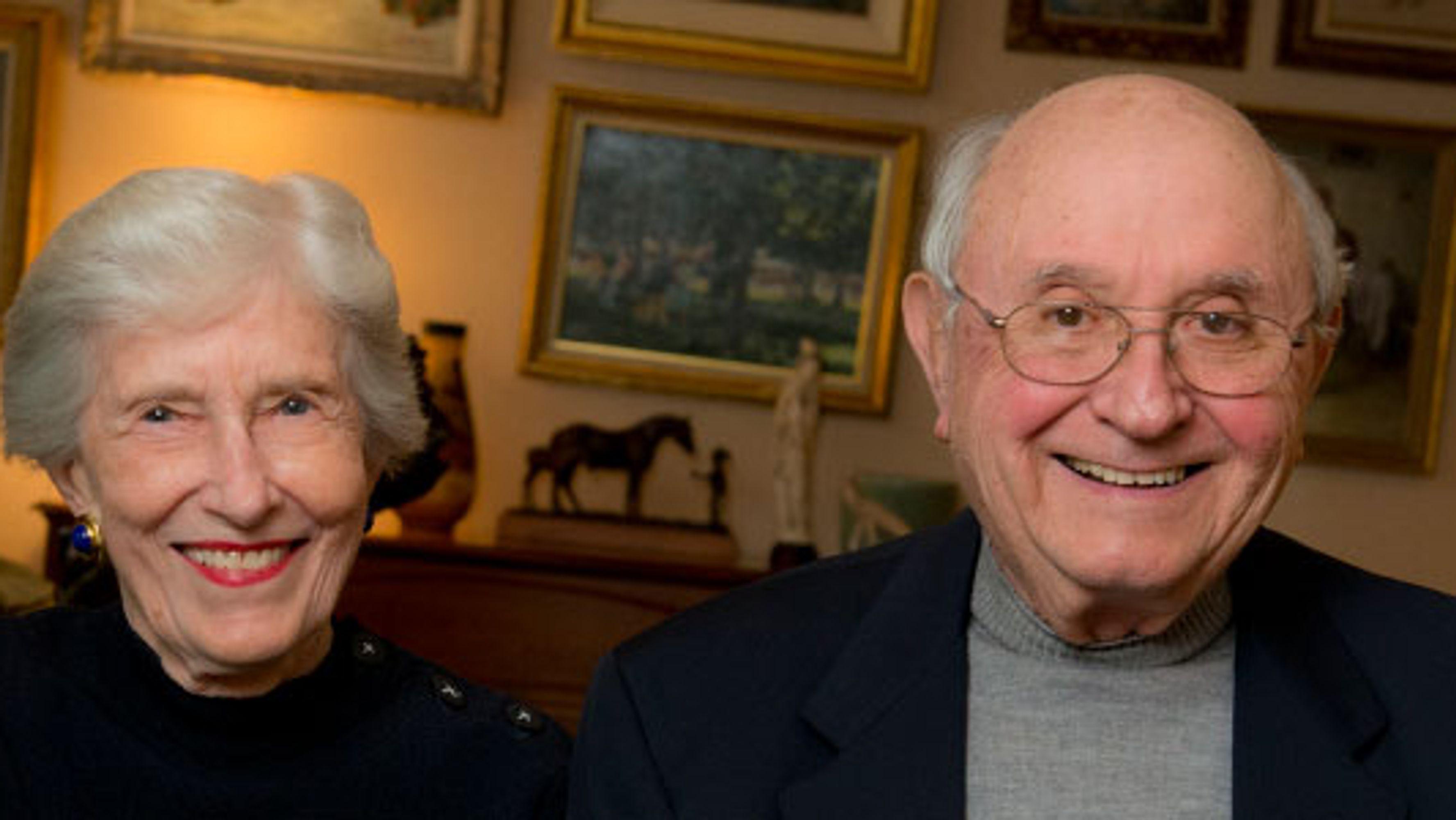 An elderly couple smiling at the camera