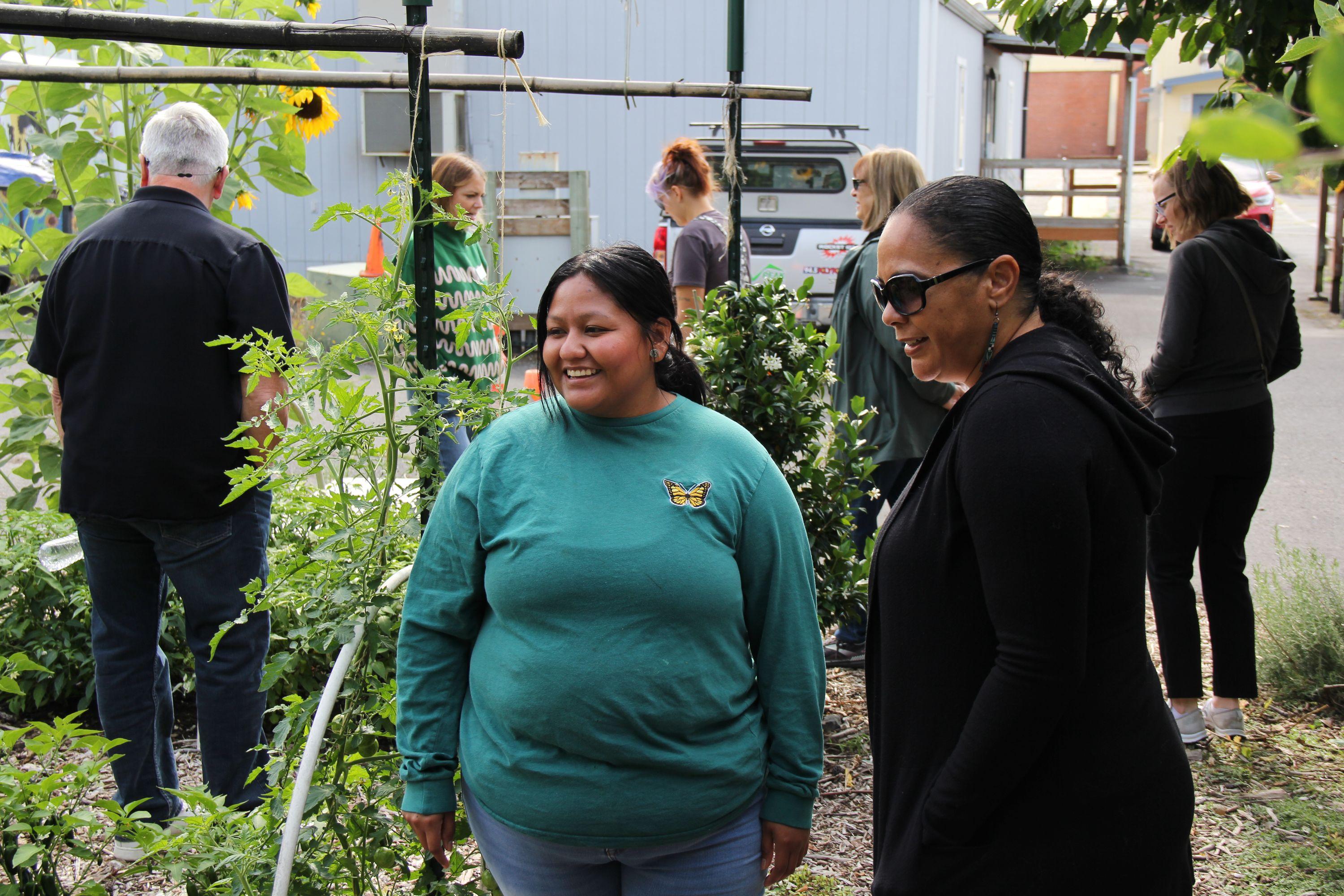 Two women of color talking in a school garden