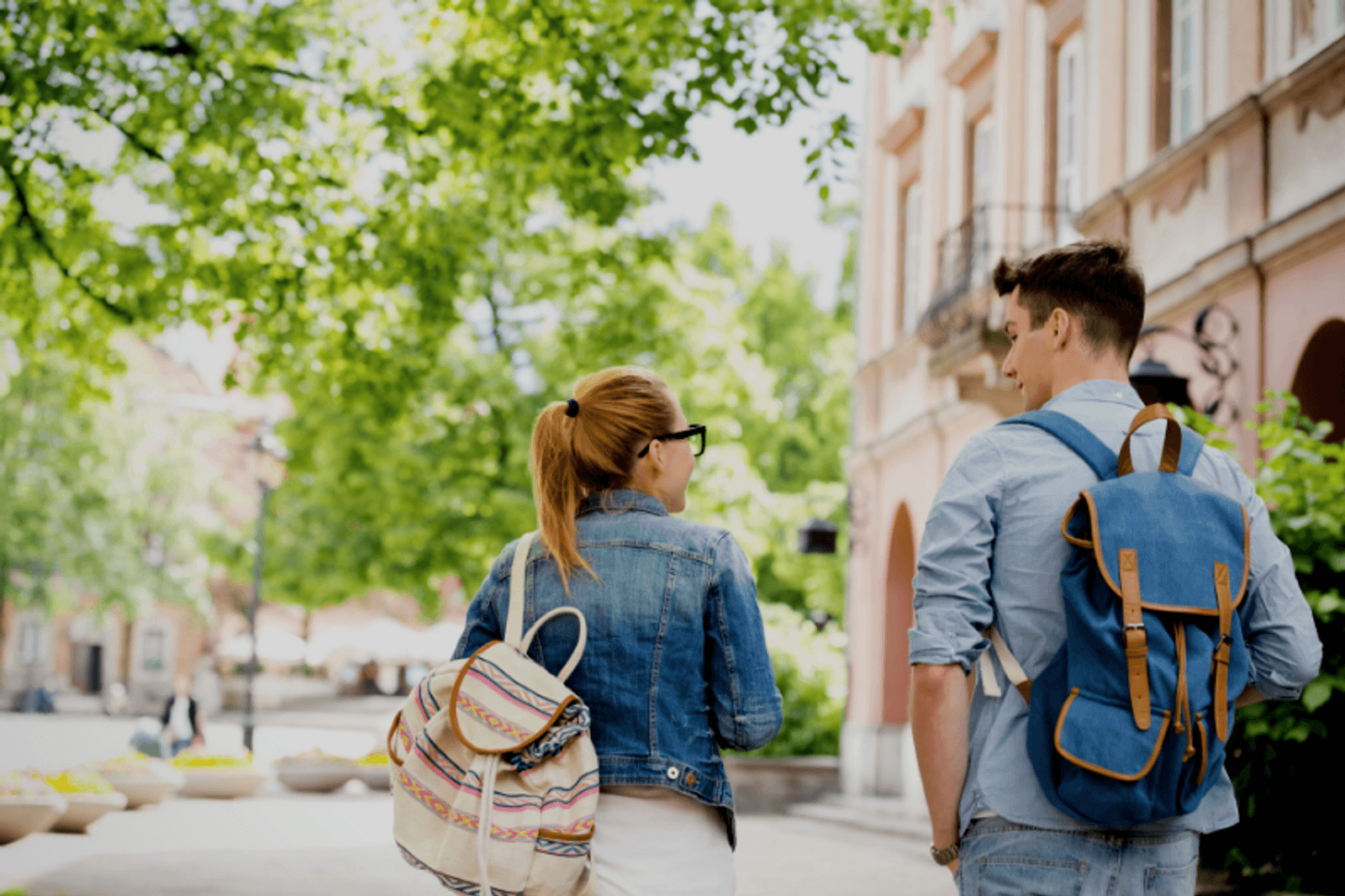 Two students walking away from the camera on campus