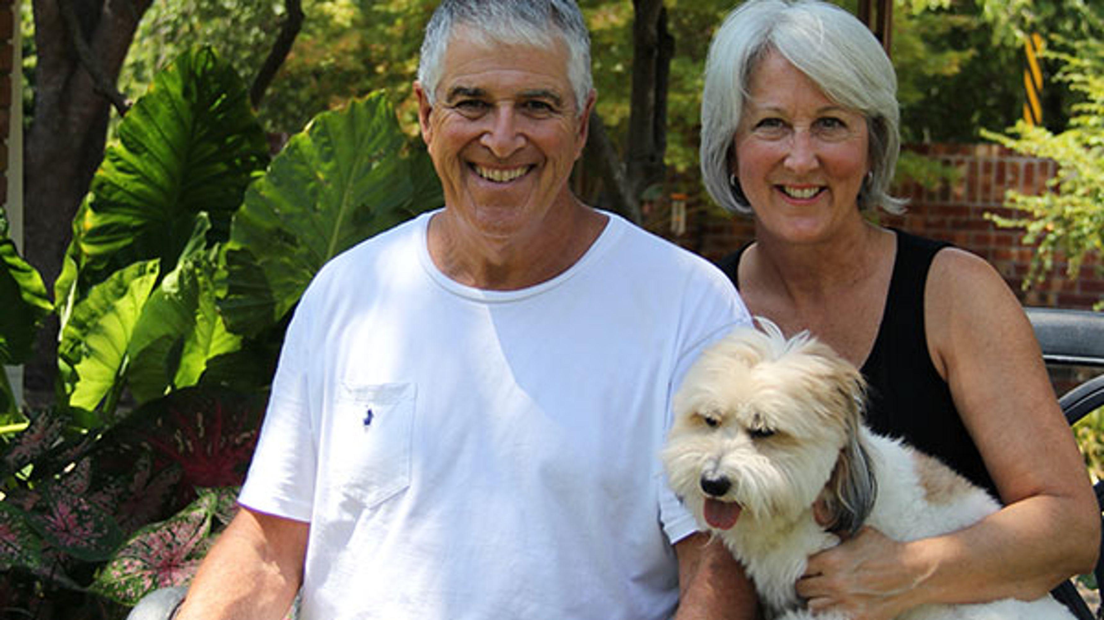 A middle-aged man and woman with a cute dog