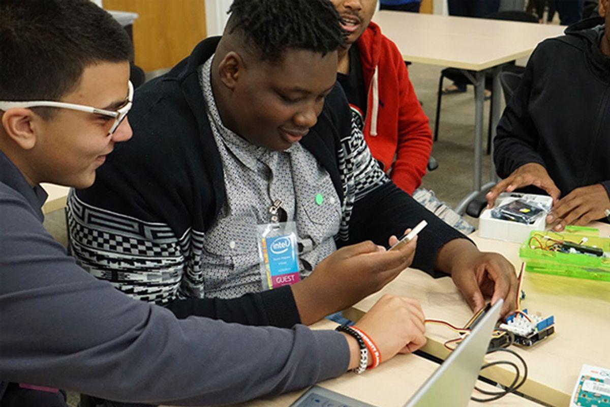 Two students looking at a laptop together at iUrban Teen in Vancouver, Washington