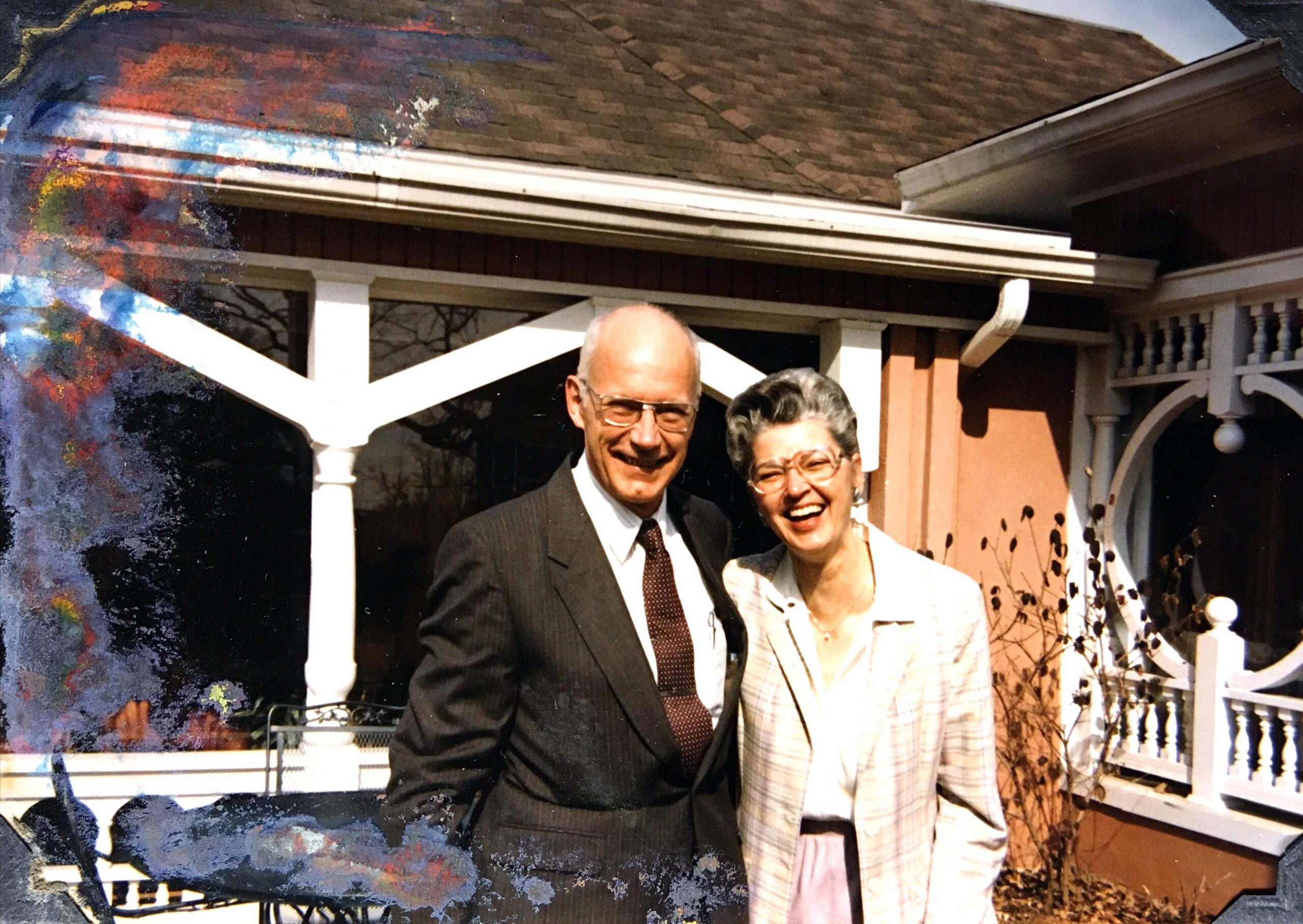 MBill and Catherine Byrd smiling in front of their home in the 1990s.